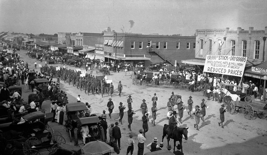 Parade in Downtown Bryan with Texas A&M Corp of Cadets. Parade was led by John Conlee. Circa 1917-1920.