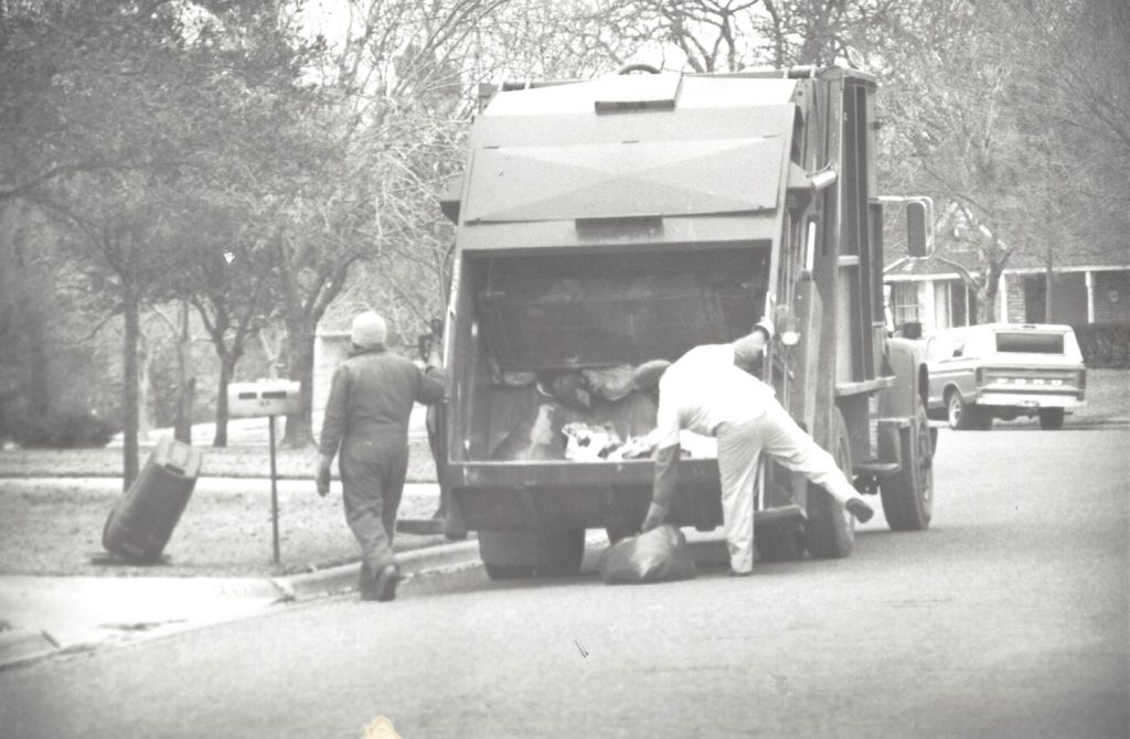 Solid Waste workers collecting trash in the 1980s or 1990s.