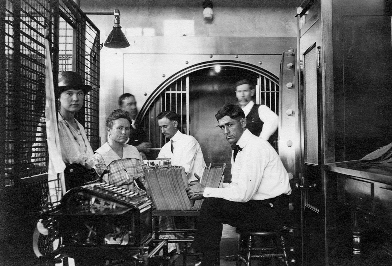 Bankers conducting business near one of the vaults at a bank on Main Street in Bryan.